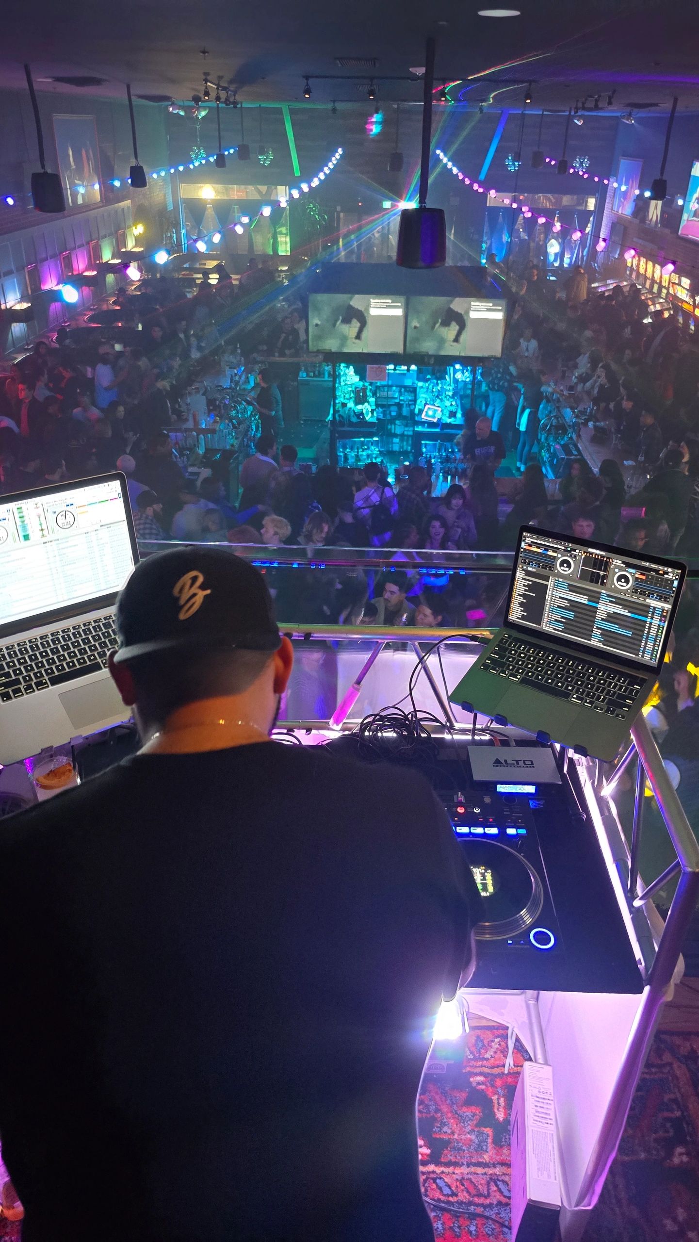 Behind the decks overlooking a dance floor
